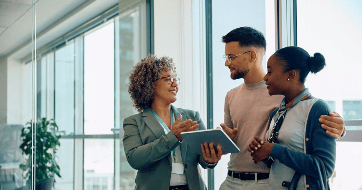 Couple With Financial Advisor Standing