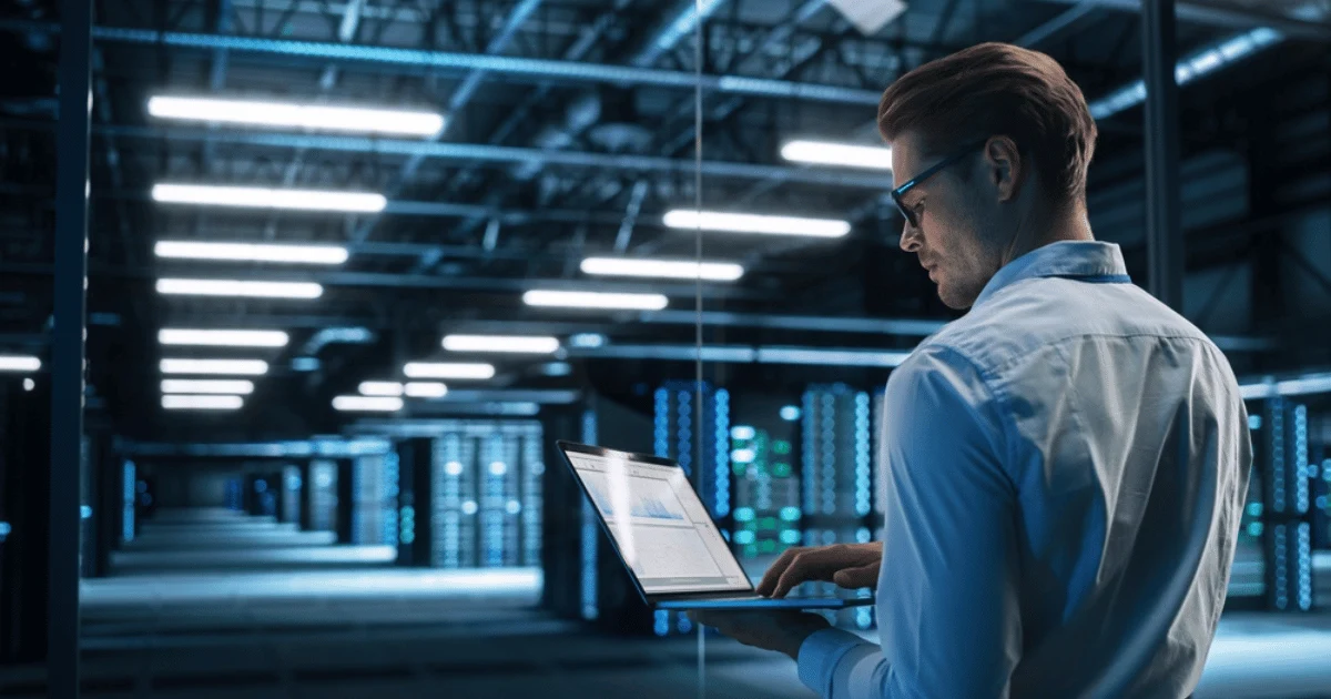 Man on Laptop in Data Center Computing Concept