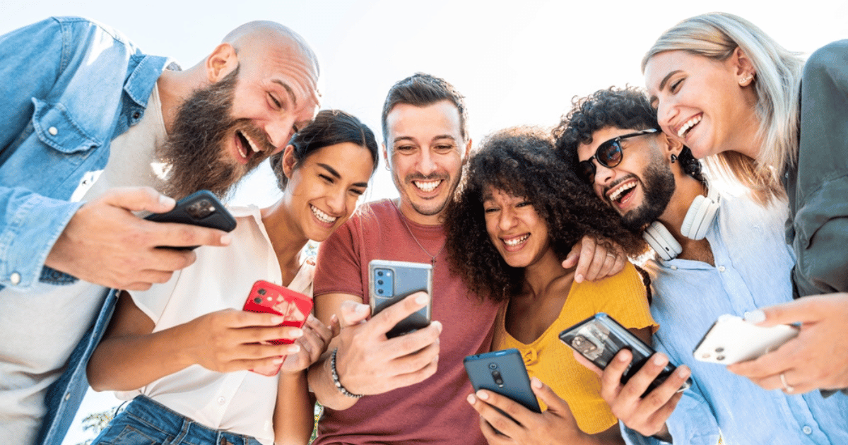 People Together Smiling Over Phones