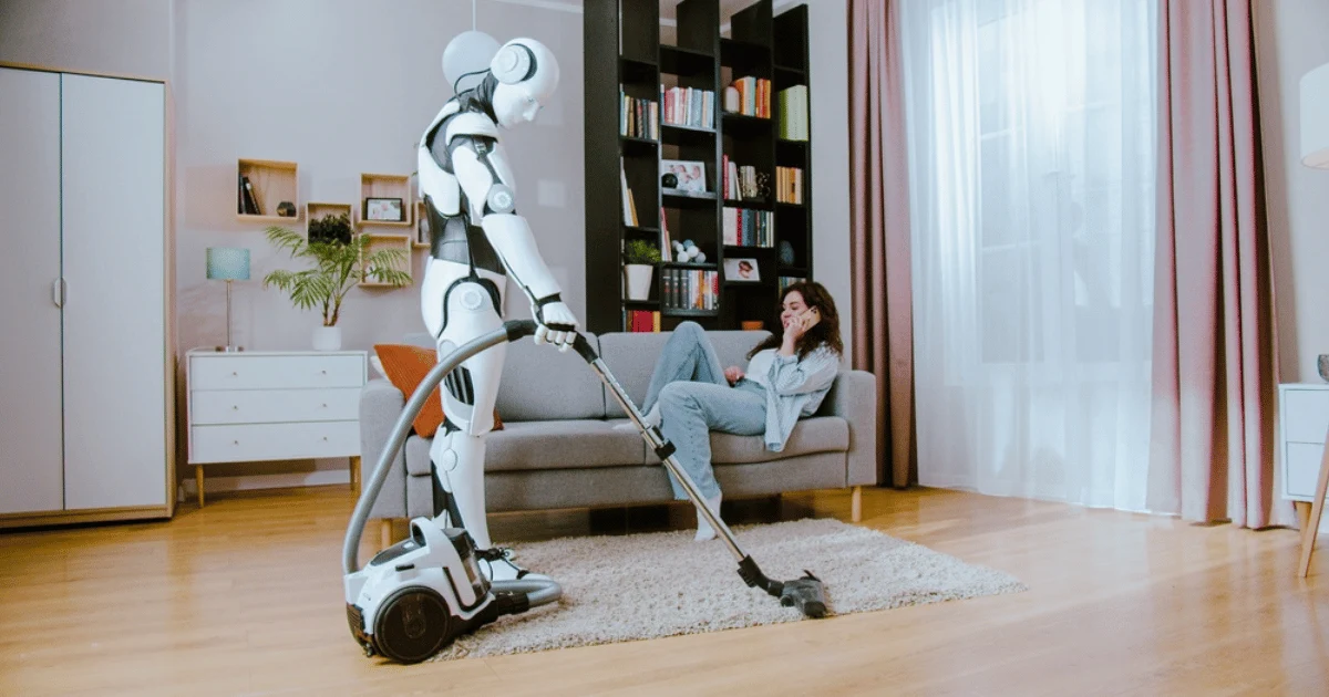 Humanoid Robot Vacumming While Woman Is on Sofa