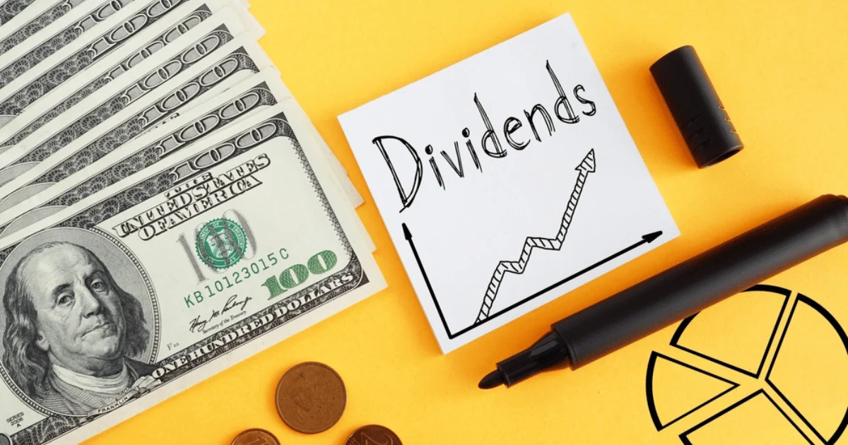 Dividends Written on Post It With Marker Money in Background